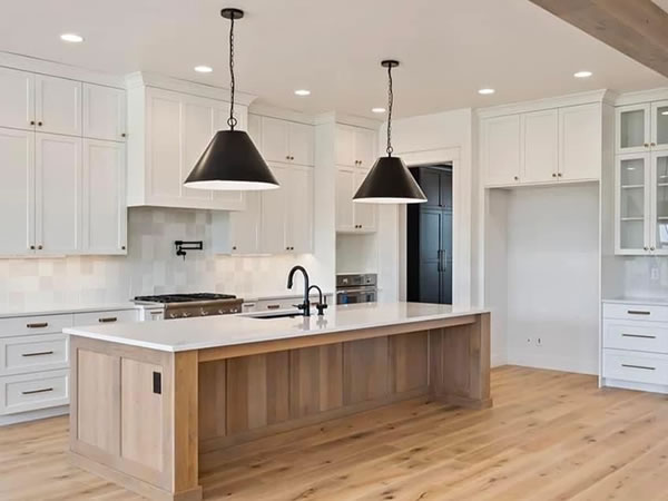 Modern kitchen remodel in Clark County, WA with white cabinets, center island, and pendant lighting